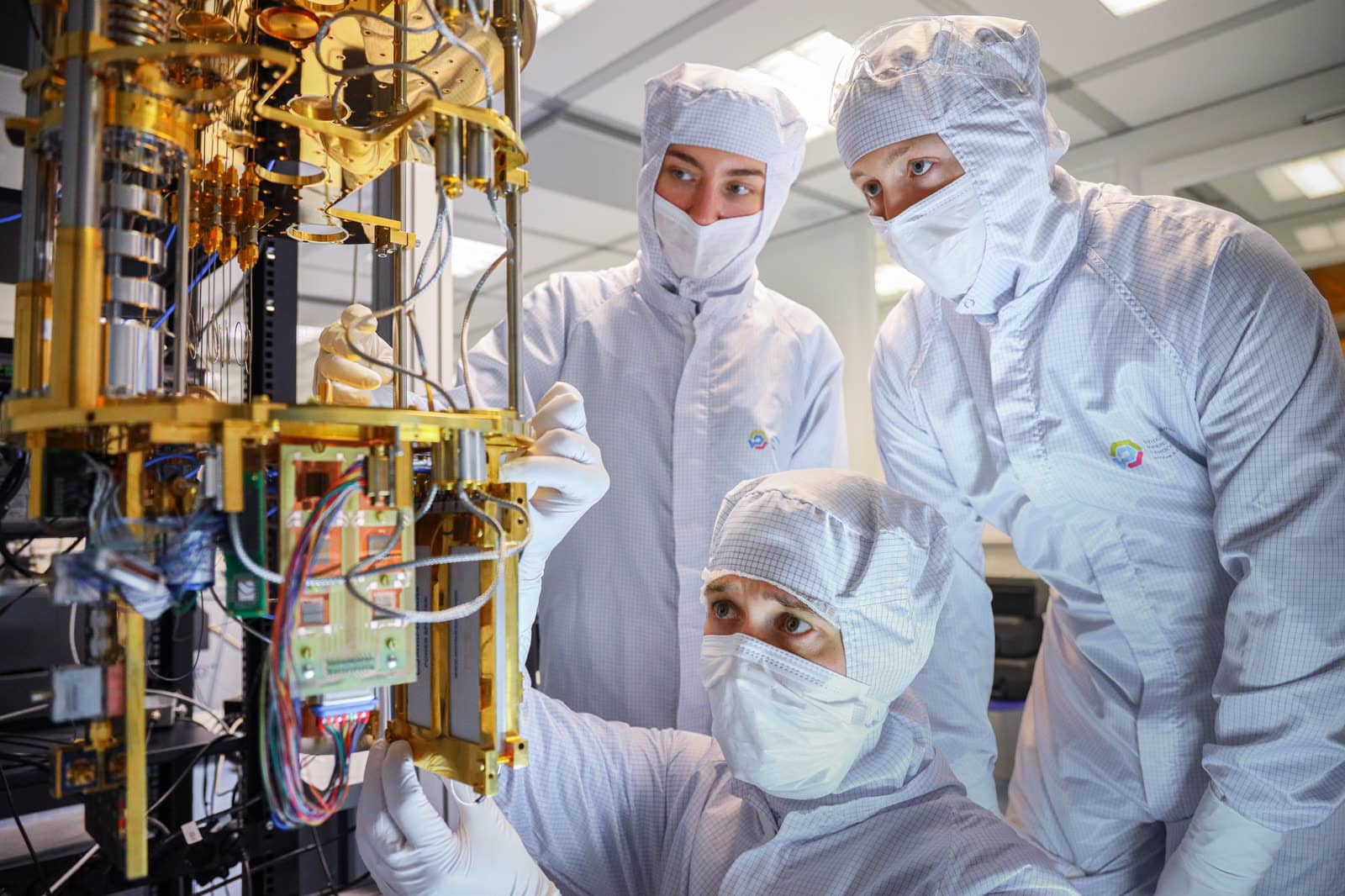 Engineers assembling the cryogenic measurement path for qubits